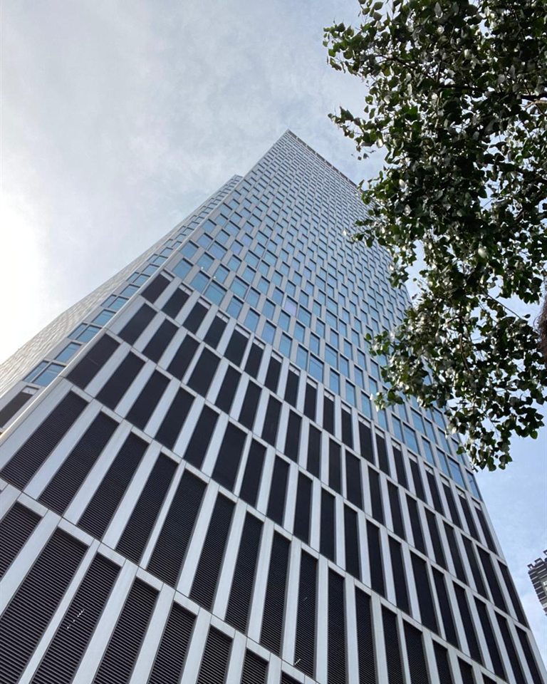 Looking up at the facade of One Lodha Place, a commercial tower in Mumbai